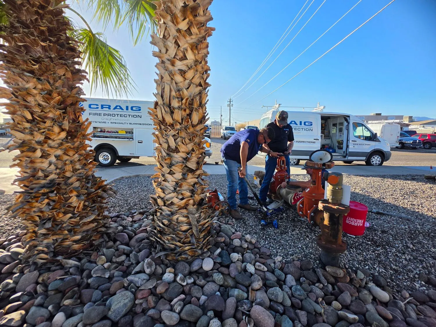 Craig Fire Protection technicians working together on a backflow assembly