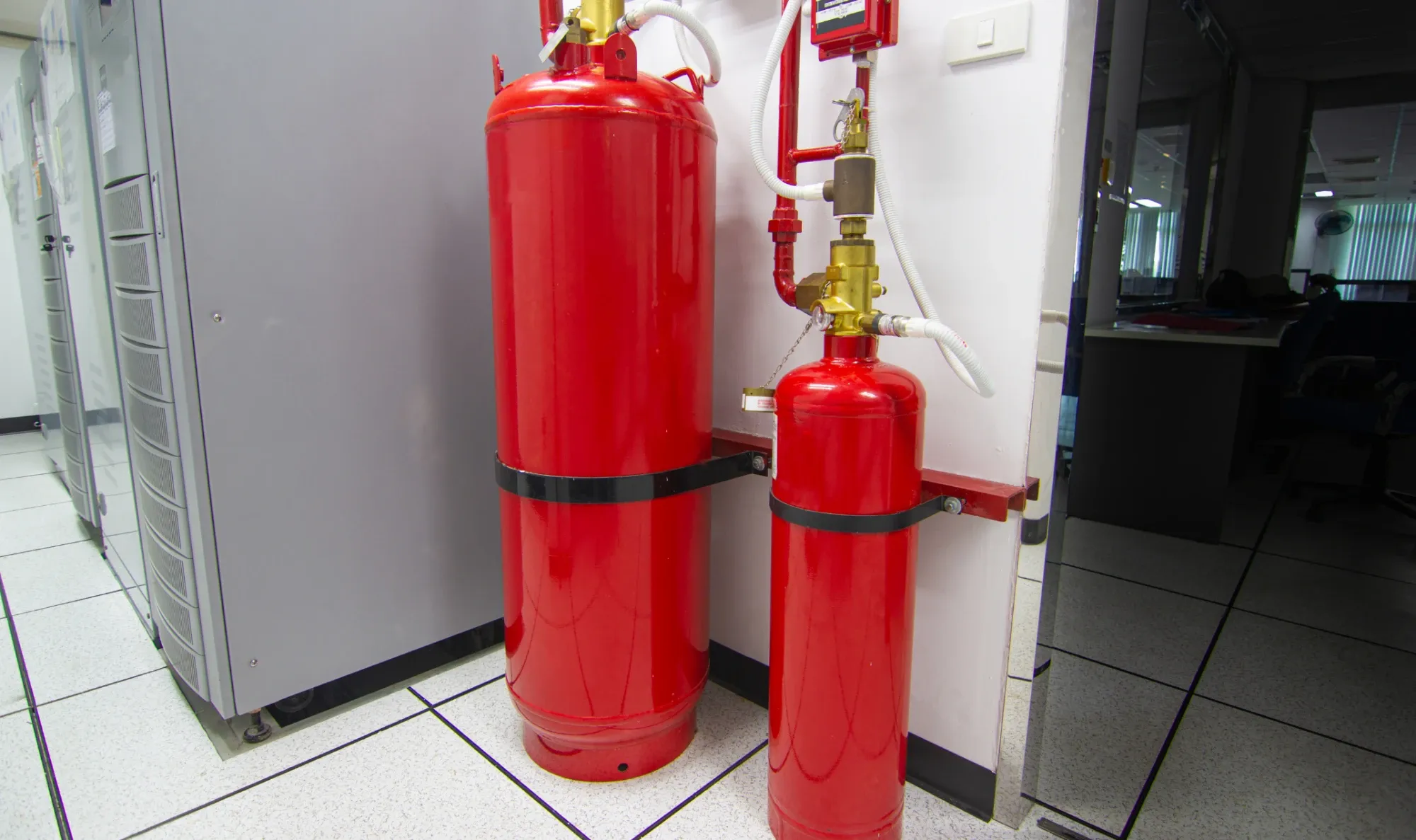 Red fire suppression cylinders mounted against a wall